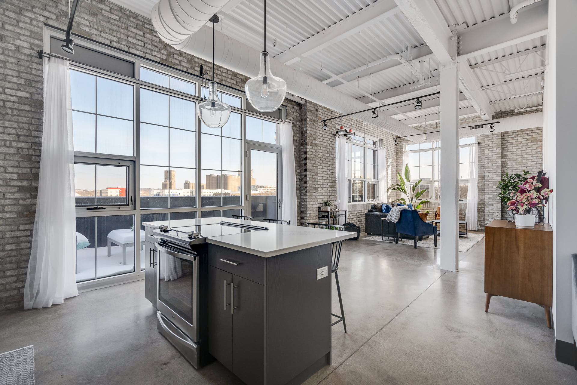 Downtown Minneapolis apartment kitchen and living area with kitchen island and large windows